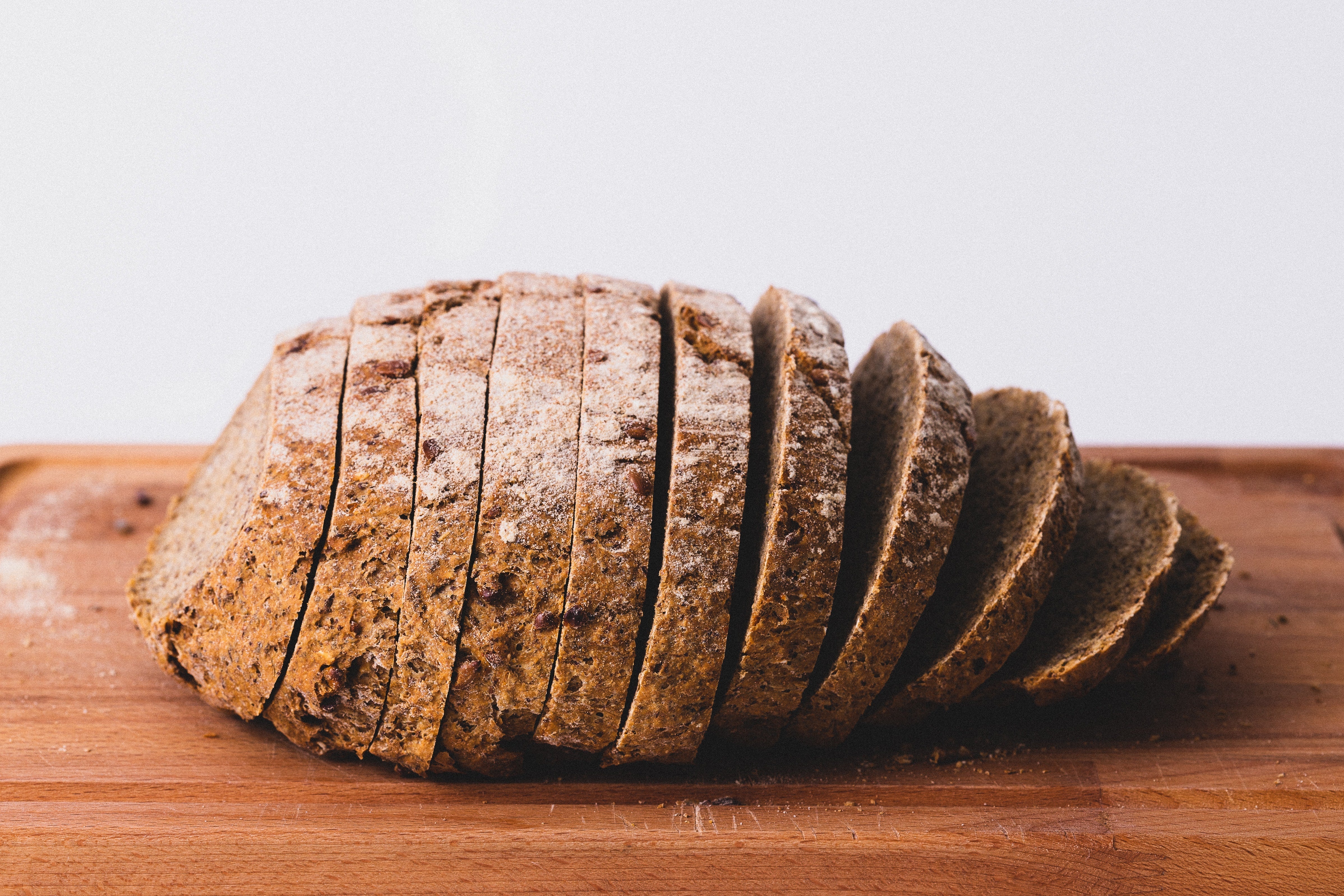 Sliced whole grain bread on a wooden cutting board