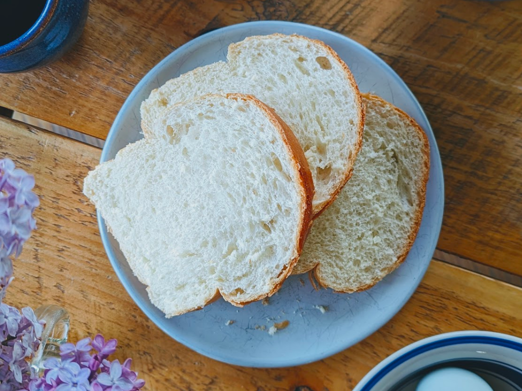 Slices of bread on a plate with a floral arrangement