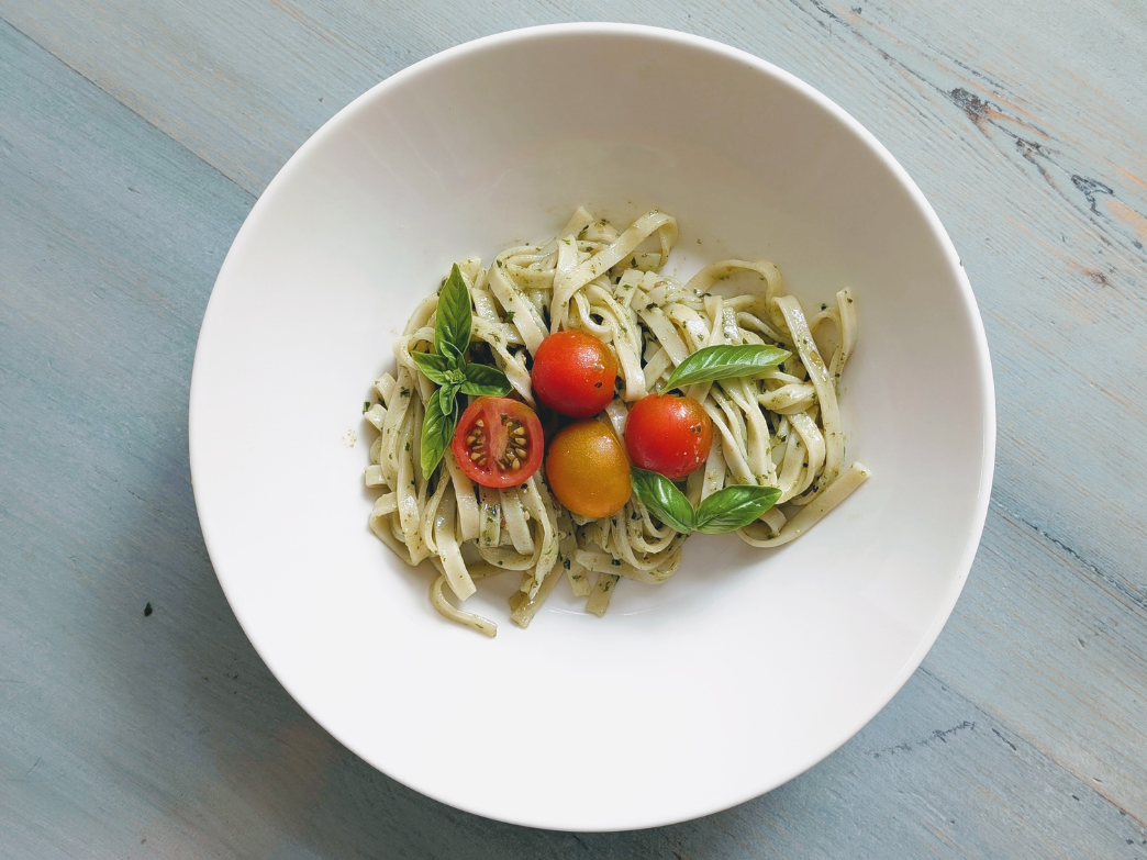 Bowl of pasta with tomatoes and basil, representing various pasta types.