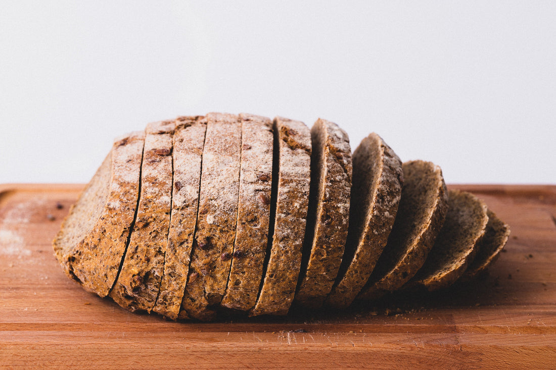 Sliced whole grain bread on a wooden cutting board