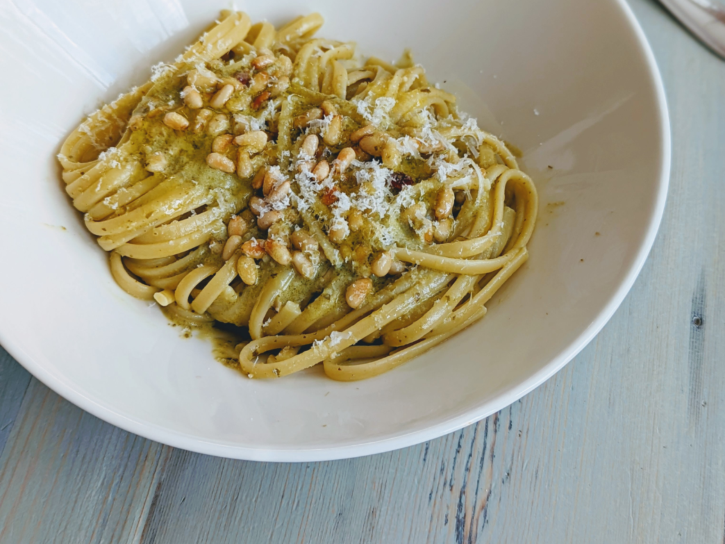 Plate of whole grain pasta with pesto and pine nuts