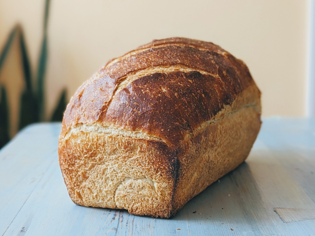 A freshly baked loaf of bread on a wooden table