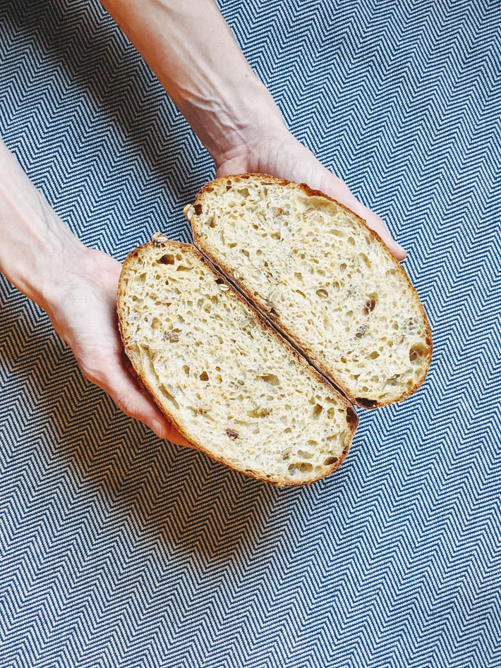 Sliced Plain Sourdough Loaf held in hands, showing texture and crumb