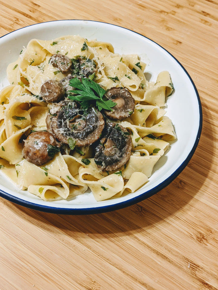 Pappardelle pasta with mushrooms and herbs in a bowl