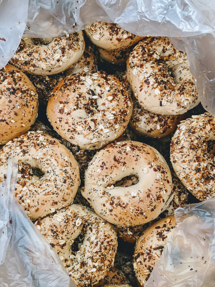 A pile of bagels with toppings in a plastic bag