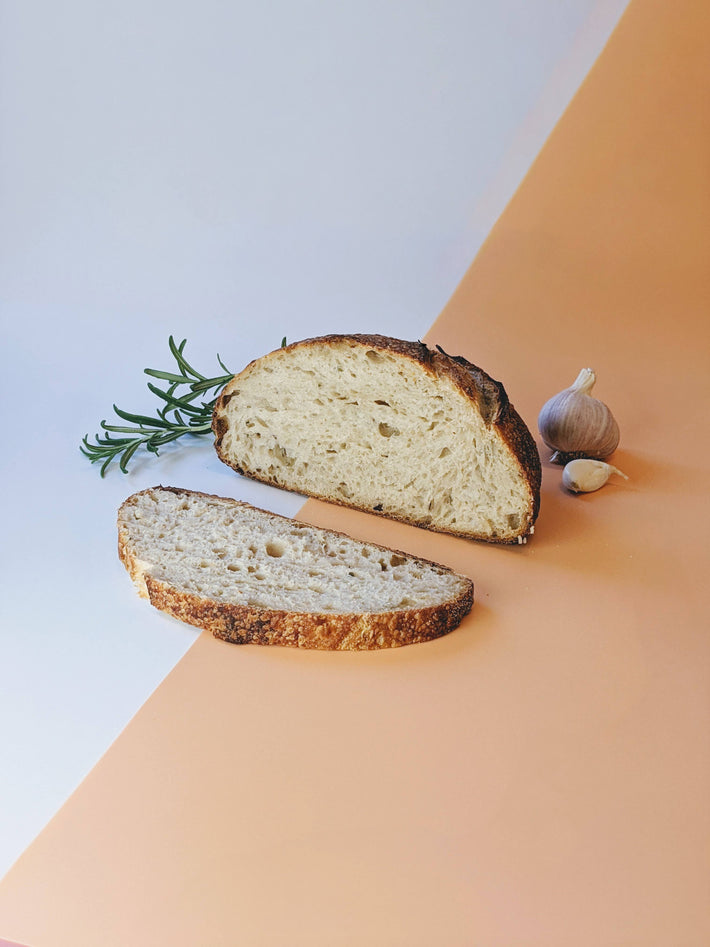 Sourdough bread with rosemary and garlic on a table