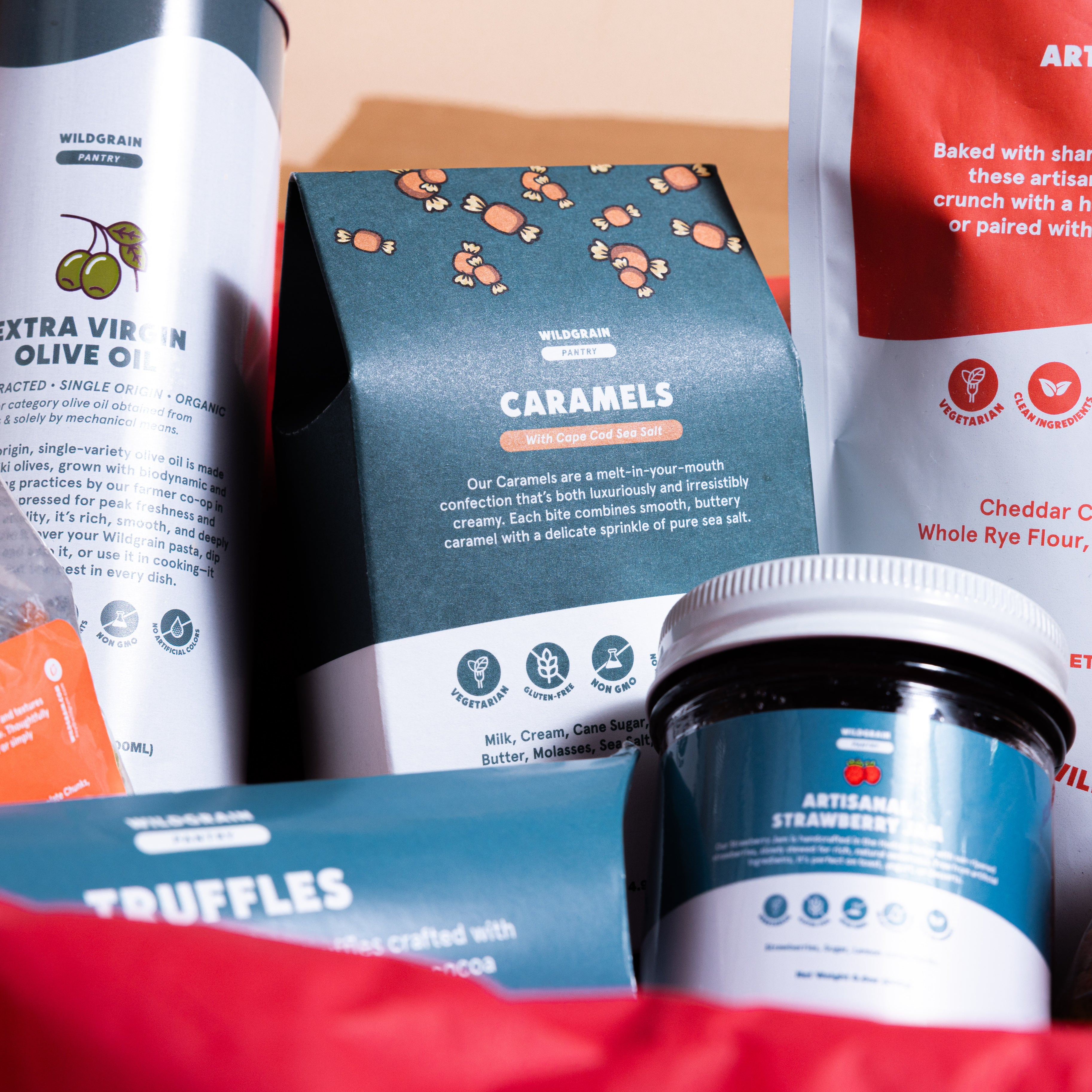 Assorted gourmet food items including truffles, caramels, and cheese crackers in a box.