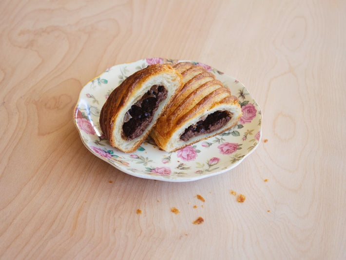 Chocolate Avalanche Croissant on a floral plate, showing chocolate filling