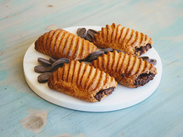 Chocolate Avalanche Croissants on a marble plate with chocolate pieces