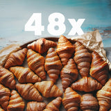 Overhead view of 4 Dozen Croissants (48-pack) showcasing flaky golden layers on a light blue background with ‘48x’ overlay