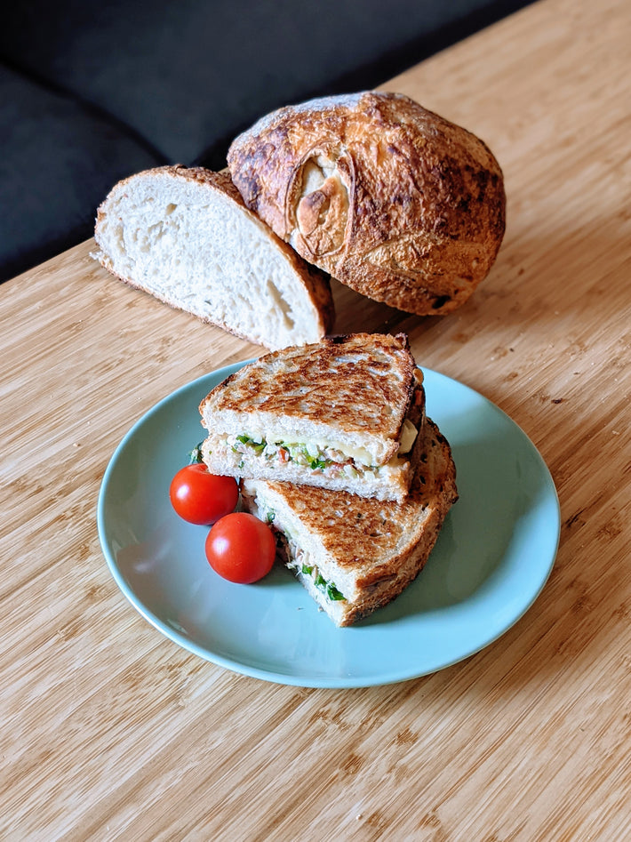 Grilled sandwich with tomatoes and sourdough bread on a plate