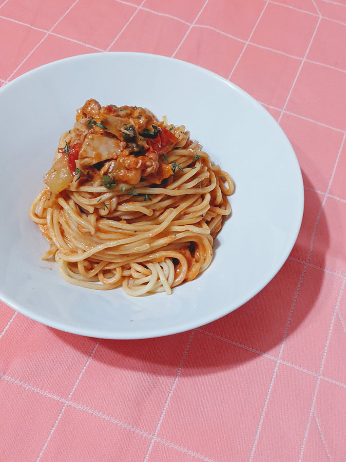 Plate of Tonnarelli pasta with sauce and herbs