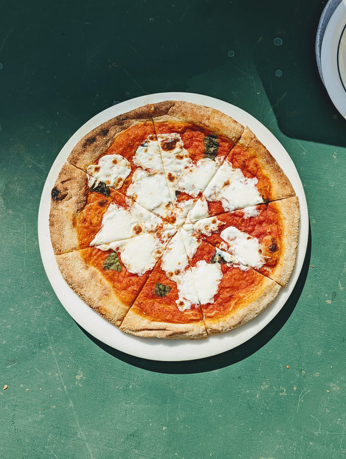 Slow-Fermented Margherita Pizza with mozzarella and basil on a plate