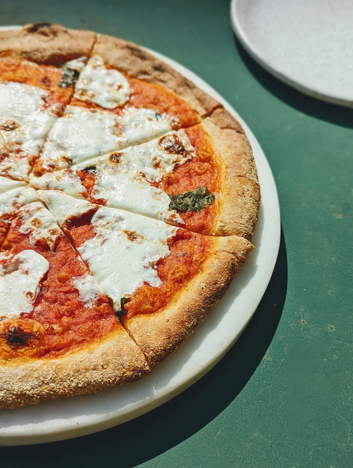 Slow-Fermented Margherita Pizza with cheese and basil on a crust