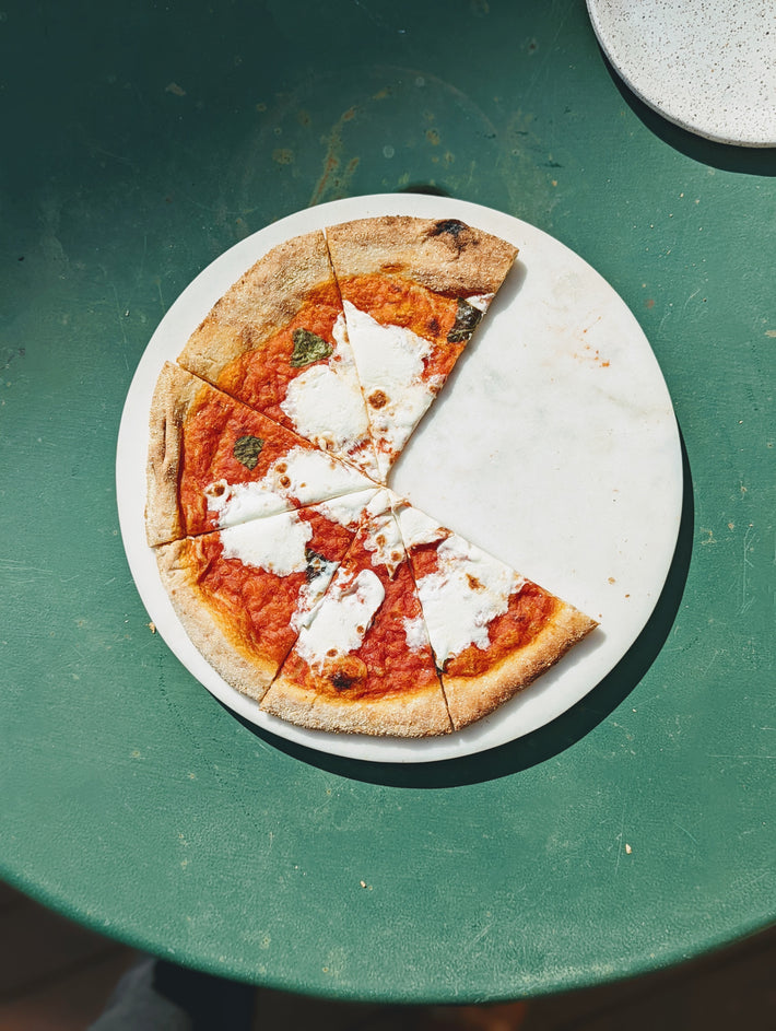Slow-Fermented Margherita Pizza slice on a white plate