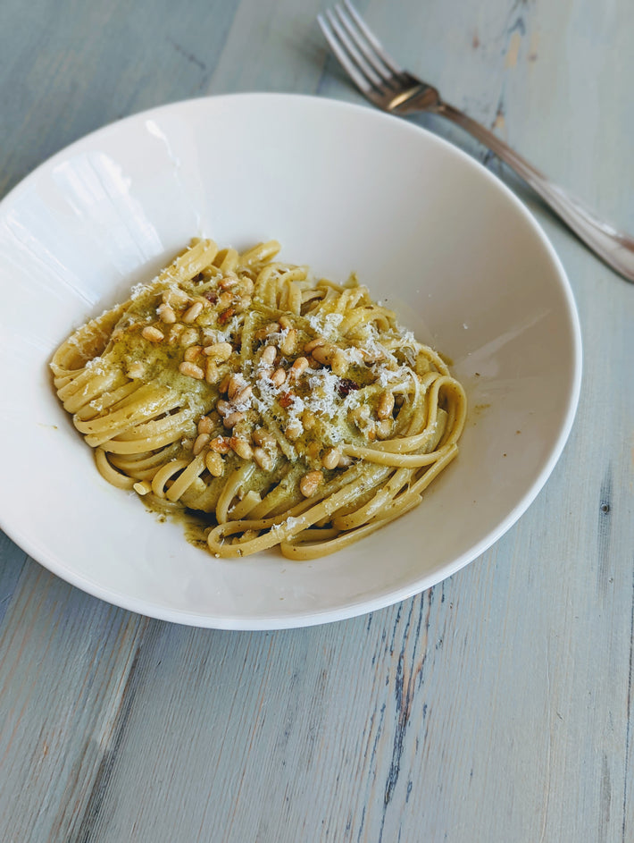 Plate of Tonnarelli pasta with pine nuts and cheese