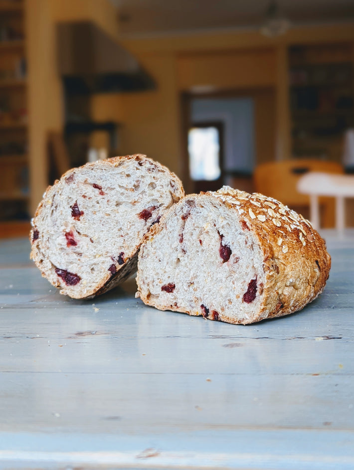 Sliced cranberry-pecan sourdough loaf showing interior with cranberries and pecans