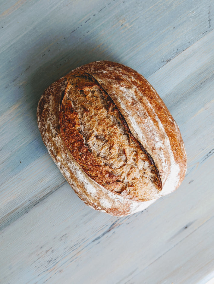 Wildgrain sourdough bread on a wooden surface