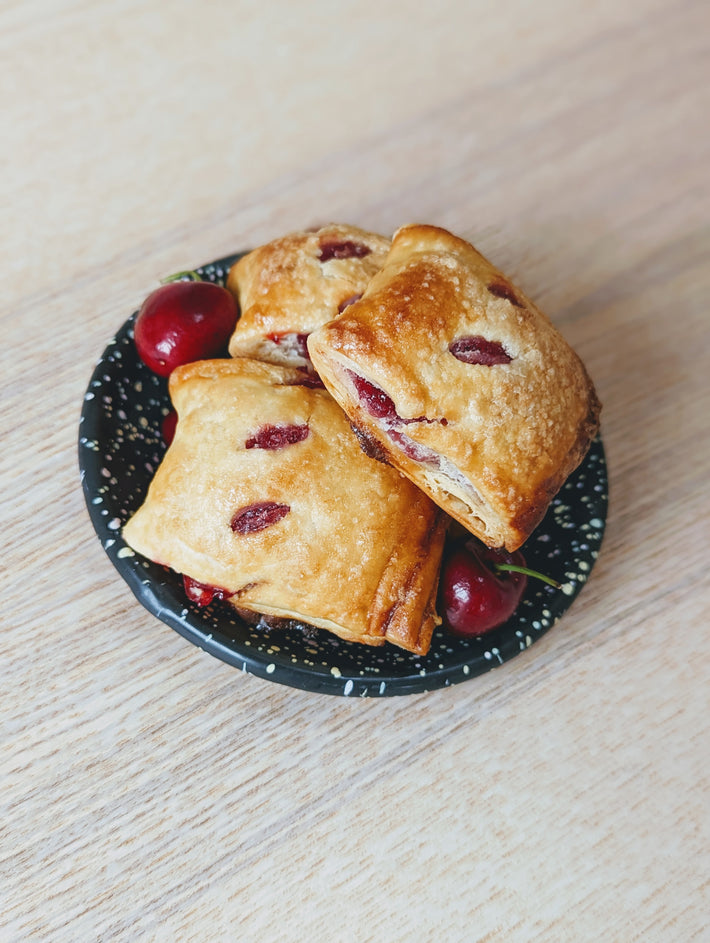 Cherry Pie Bites on a plate with cherries