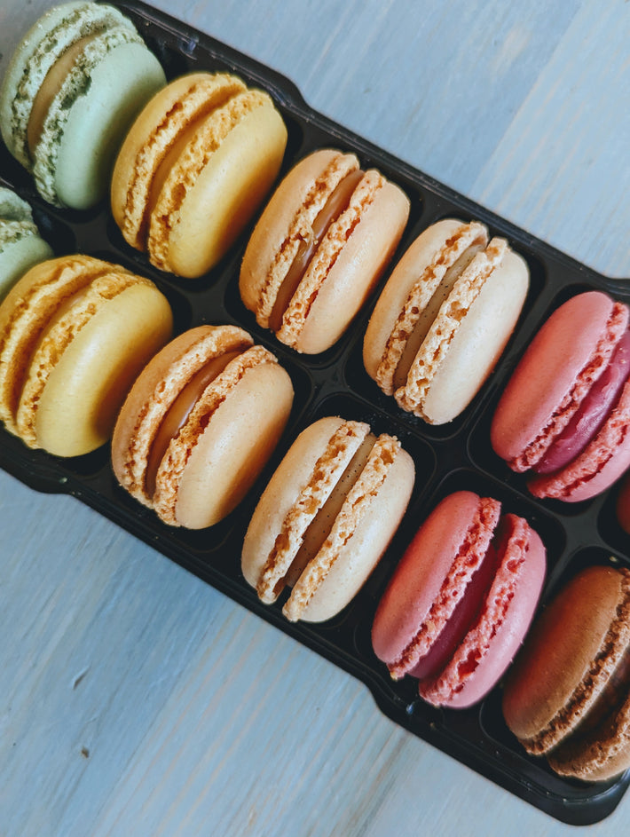 Colorful macarons in various flavors arranged in a tray