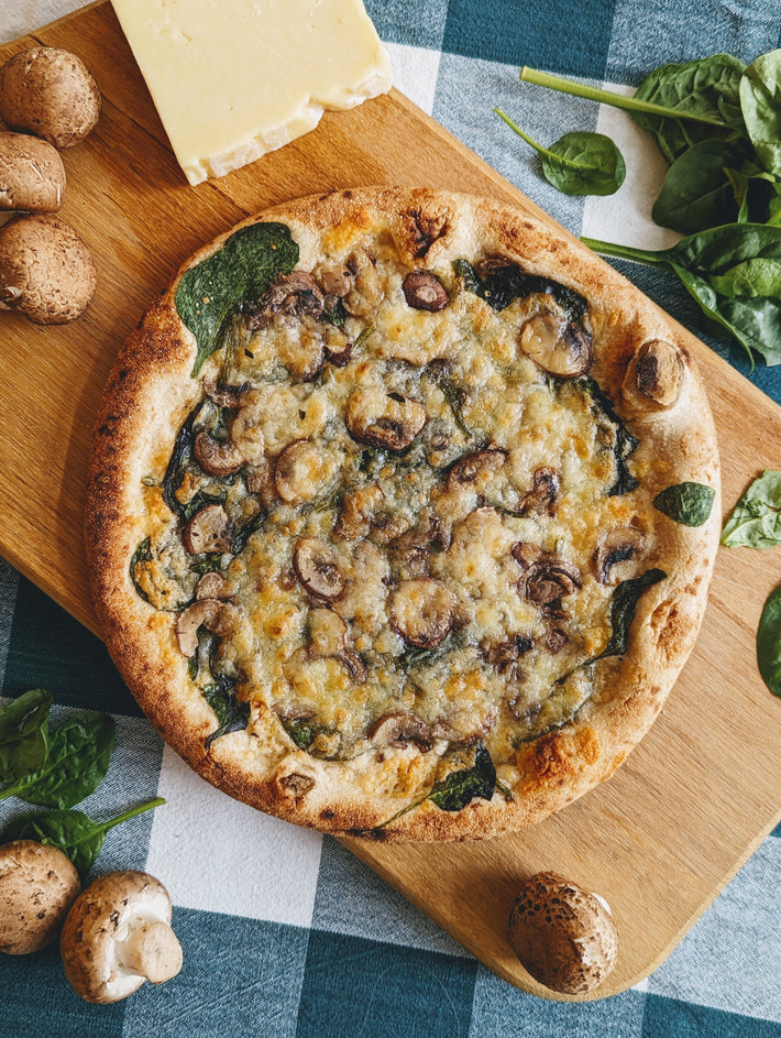 Slow-Fermented Veggie Pizza topped with mushrooms and spinach