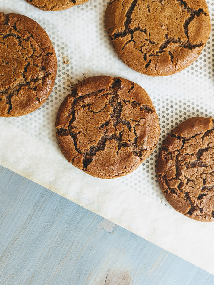 Giant Ginger Molasses Cookies on parchment paper