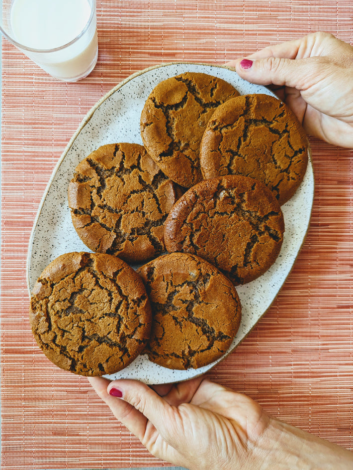 Giant Ginger Molasses Cookies on a plate, served with milk