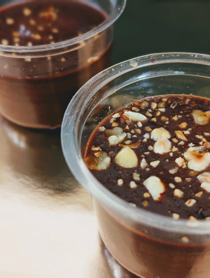 Chocolate mousse topped with crunchy hazelnuts in clear cups