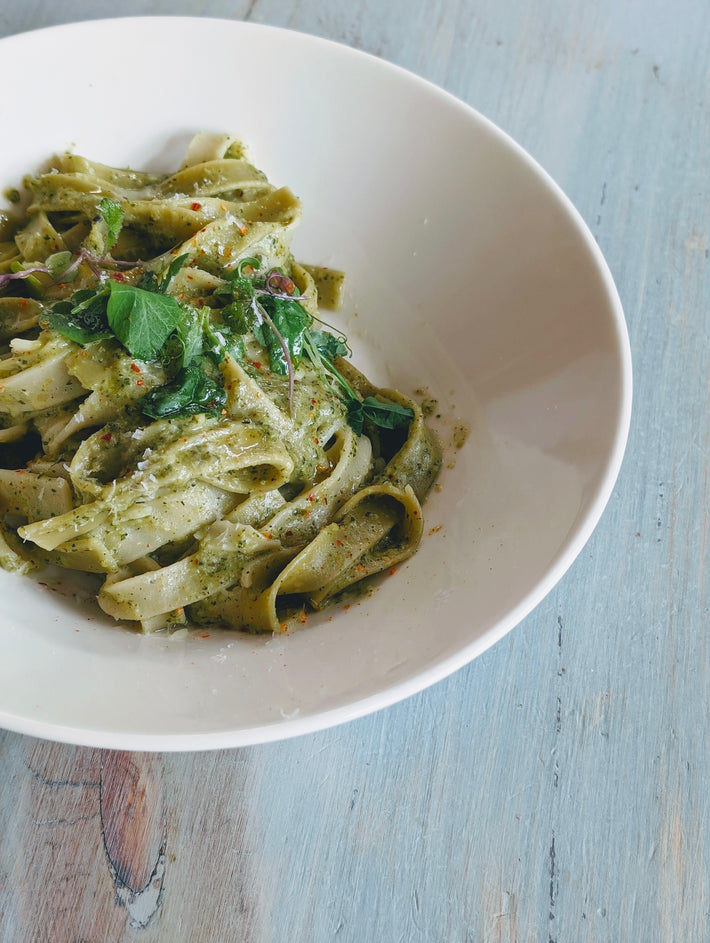 Bowl of Pappardelle pasta with pesto and herbs