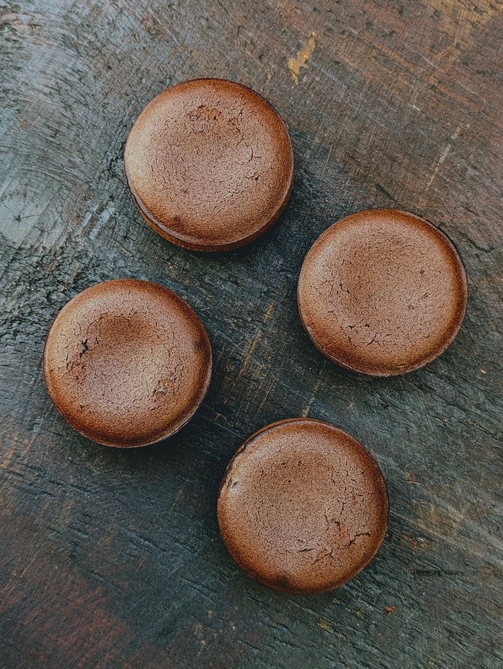 Four Chocolate Lava Cakes on a wooden surface