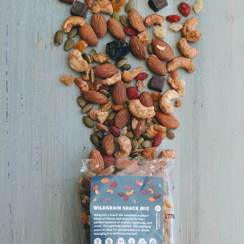 Packaged wild grain snack mix with visible ingredients on a wooden surface