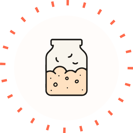 Glass jar of bubbling fermenting starter with air bubbles, centered in white circle surrounded by orange radial tick marks