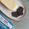 Truffle butter block and sliced truffle on speckled plate; package: WILDGRAIN Le Gall Truffle SLOW-CHURNED FRENCH BUTTER