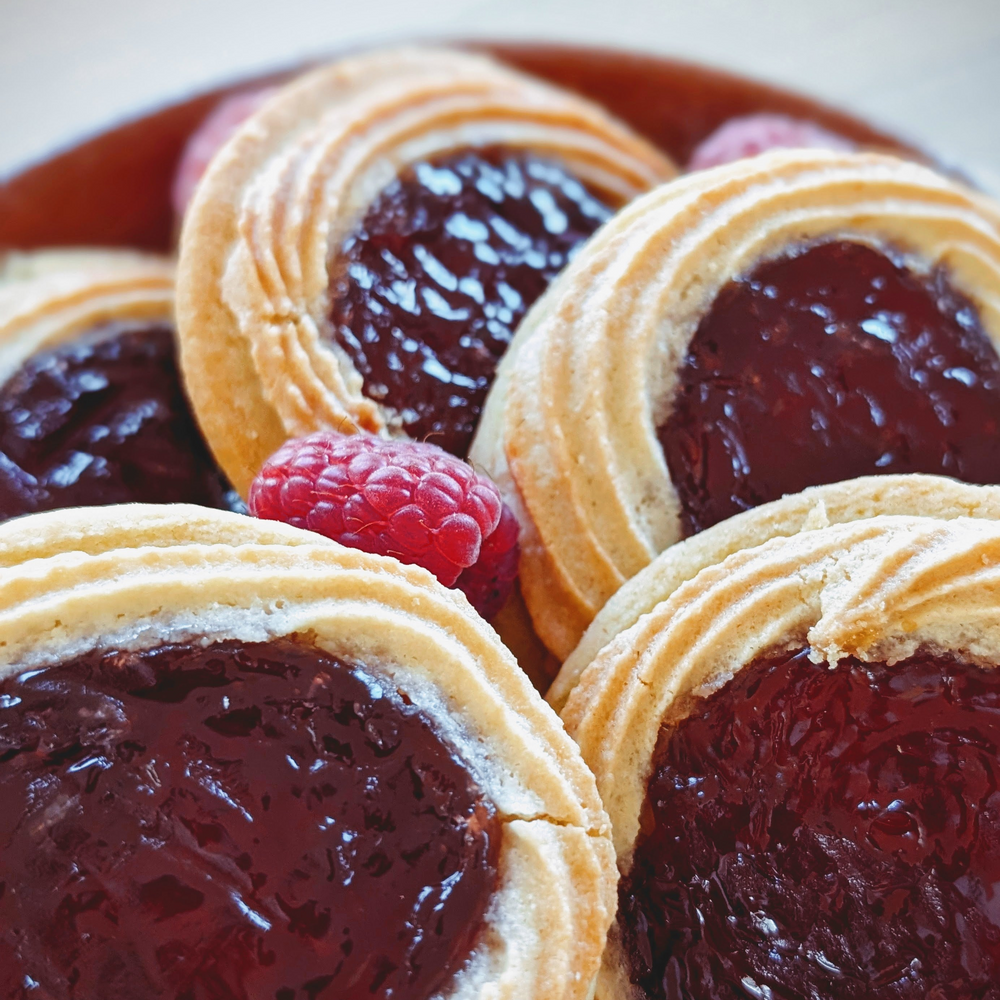 buttery thumbprint cookies filled with raspberry jam, topped with a fresh raspberry