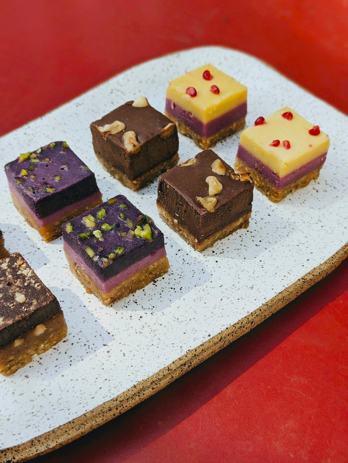 Layered desserts with various toppings on a plate