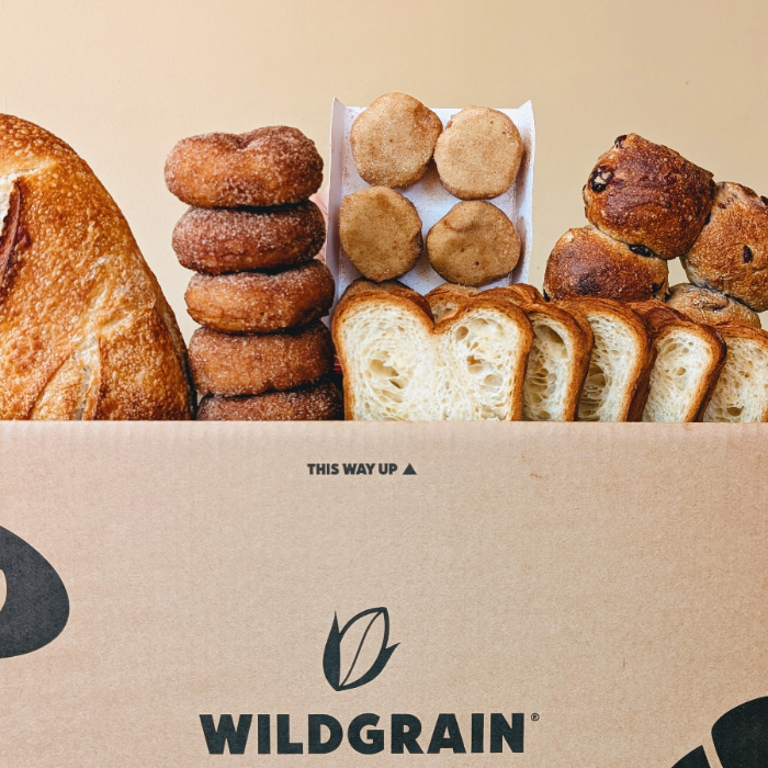 Assorted baked goods including bread and donuts in a Wildgrain box.