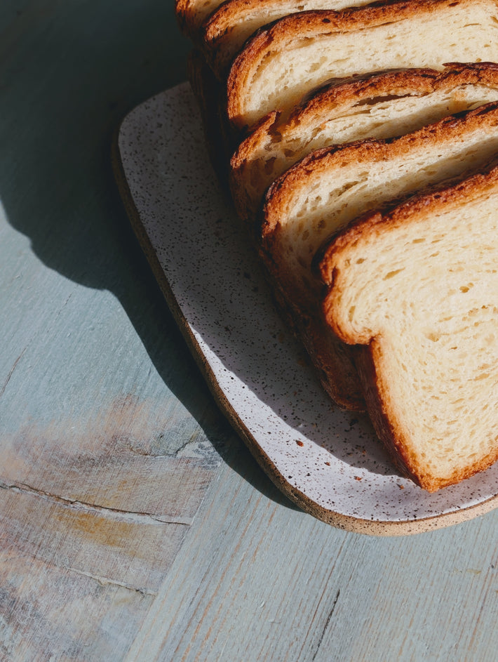 Sliced Croissant Loaf on a speckled plate, showcasing its texture and color.