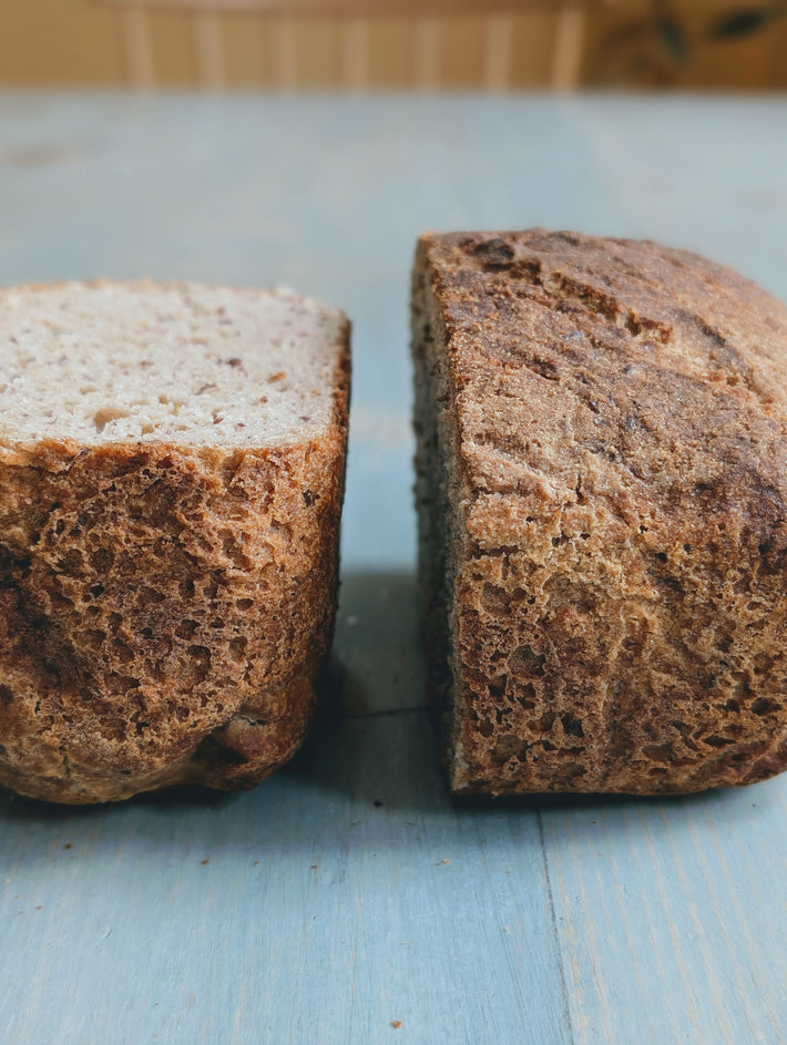 Gluten-Free Sourdough Loaf: Two slices, one light and fluffy, the other dark and dense.