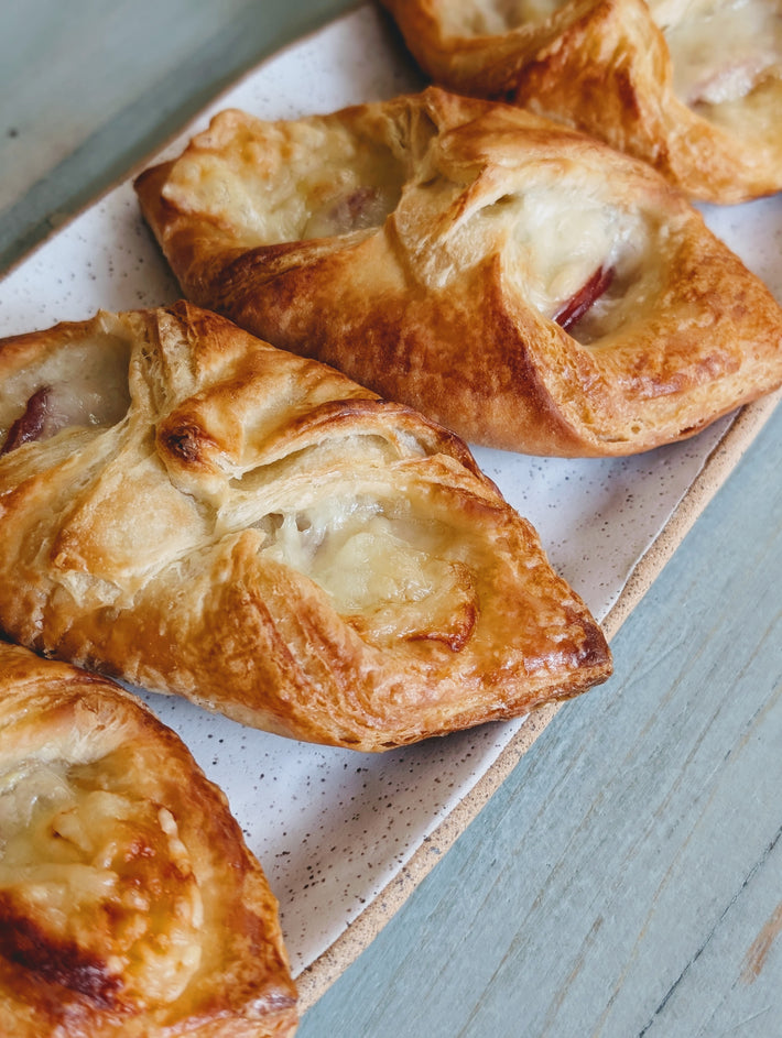 Ham & Cheese Croissants on a plate, golden-brown and flaky.