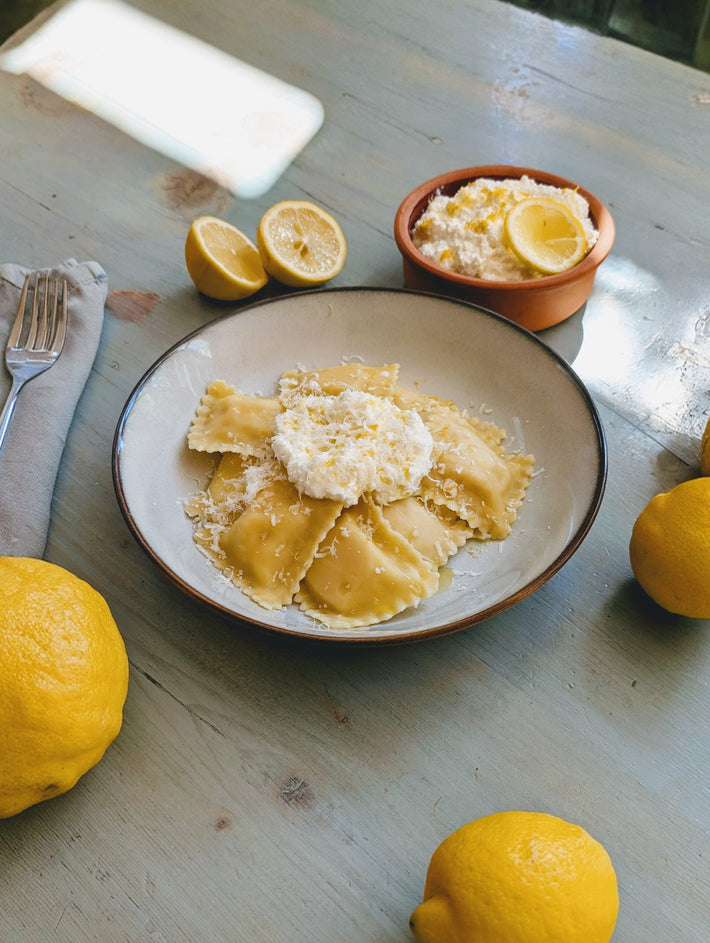 Ricotta and lemon ravioli served with ricotta and fresh lemons.