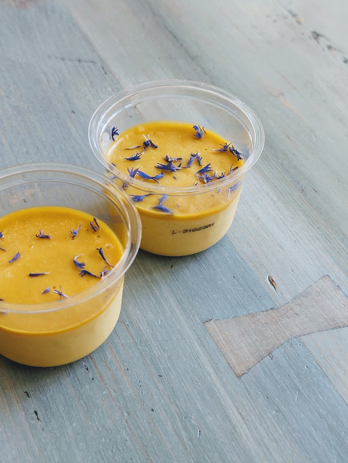Mango & Passion Fruit Mousse topped with cornflower petals in two cups