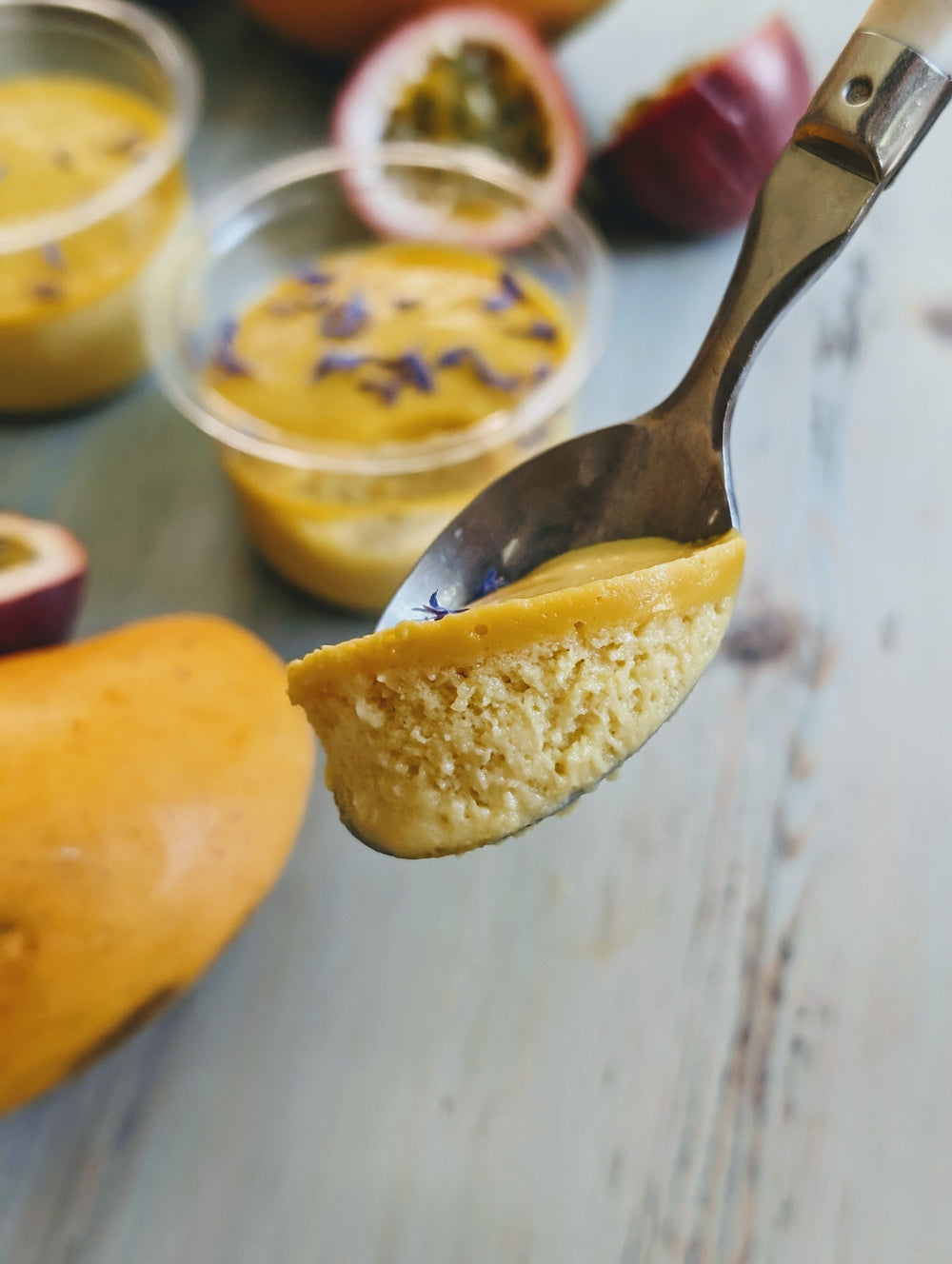 Spoonful of Mango & Passion Fruit Mousse with cornflower petals