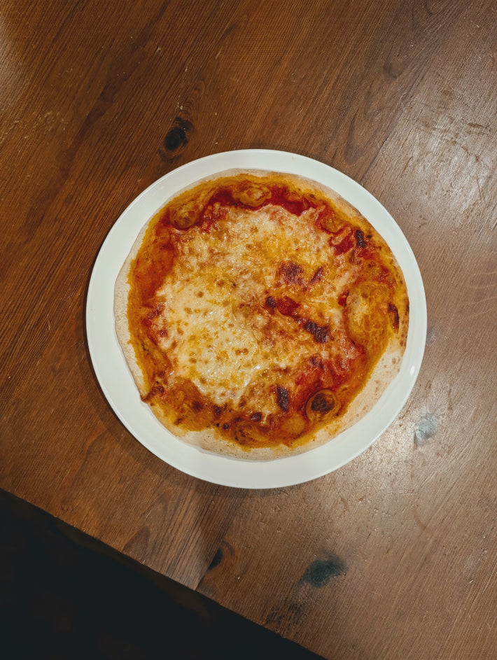 Slow-Fermented New York Cheese Pizza on a white plate.