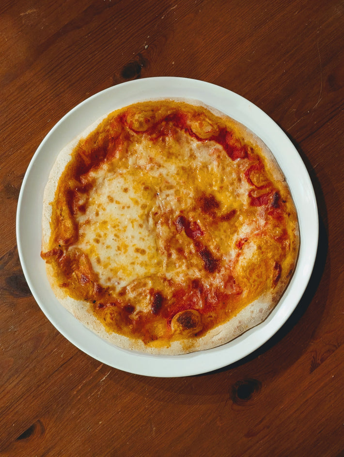 Slow-Fermented New York Cheese Pizza on a white plate.