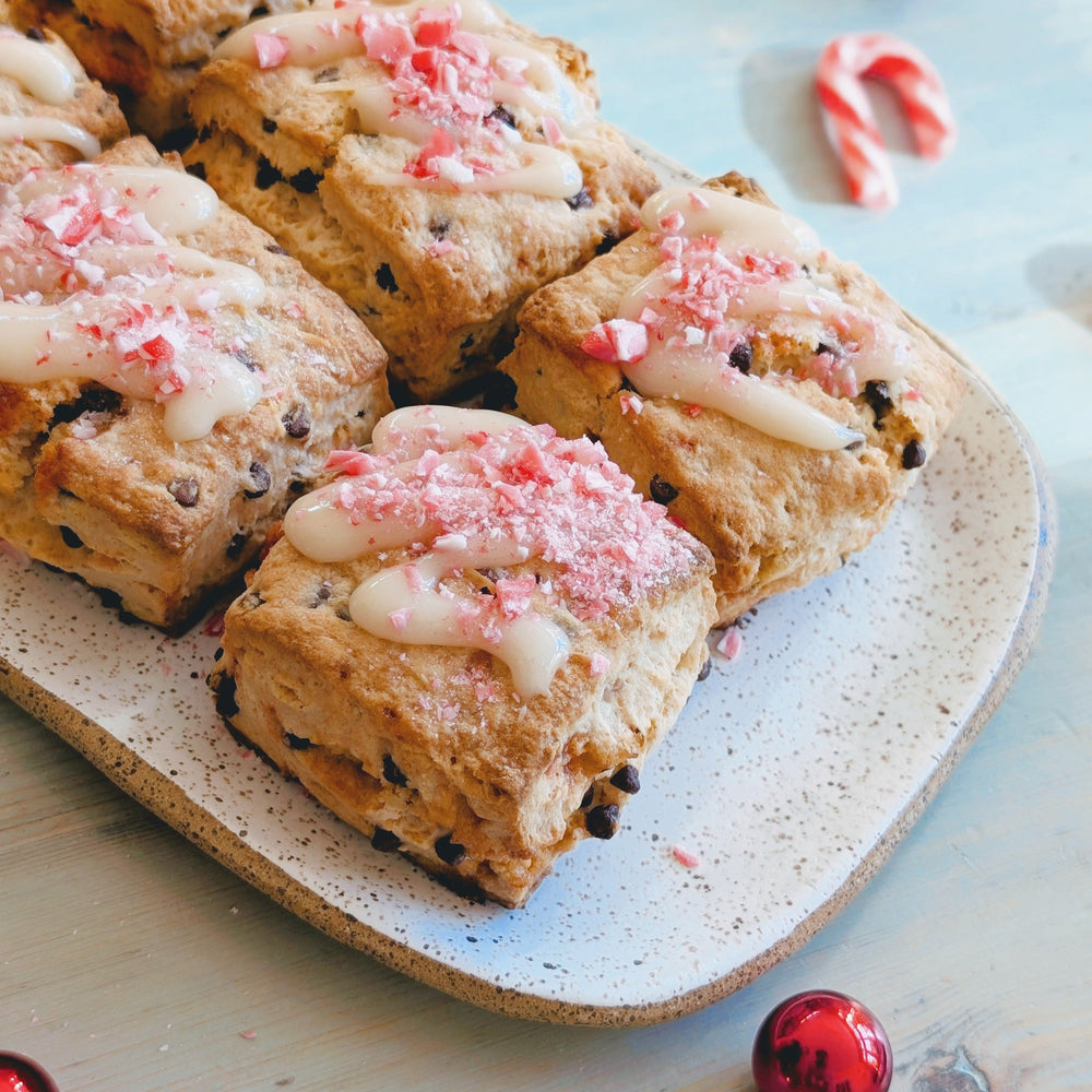 A platter of Peppermint-Chocolate Biscuits topped with crushed peppermint and icing.