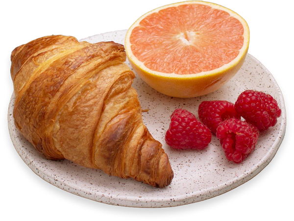 Croissant, half grapefruit, and raspberries on a speckled ceramic plate.