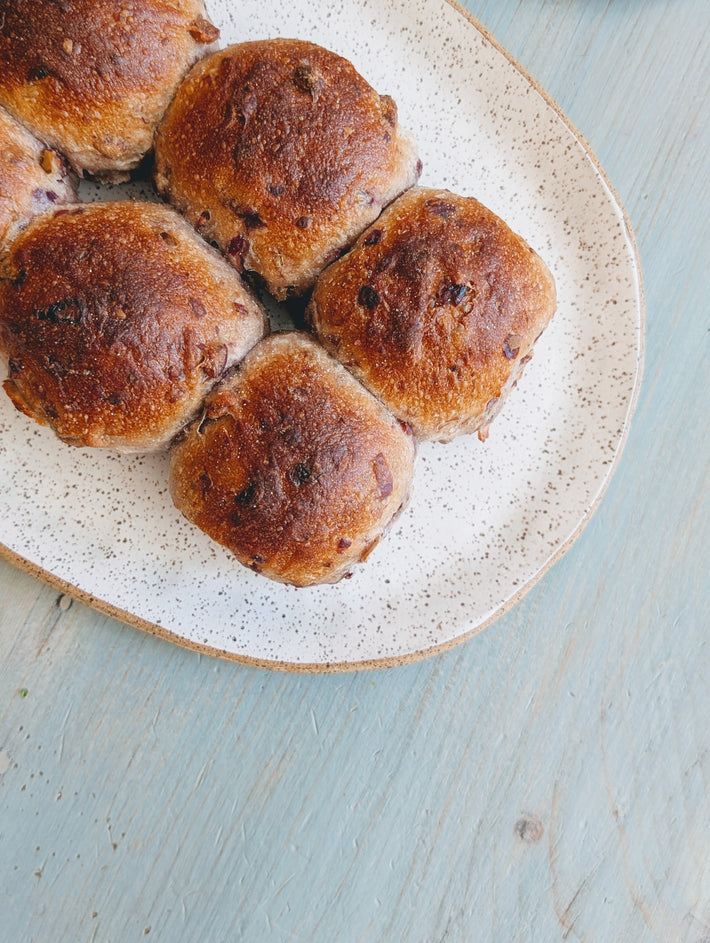 Tear & Share Cranberry-Pecan Rolls on a speckled plate, freshly baked and golden-brown.