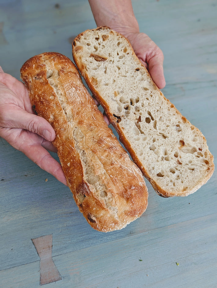 Slow-Fermented Garlic Demi Ciabattas, one whole and one sliced, showing texture.