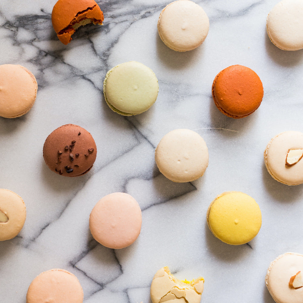 Colorful assortment of macarons on a marble surface