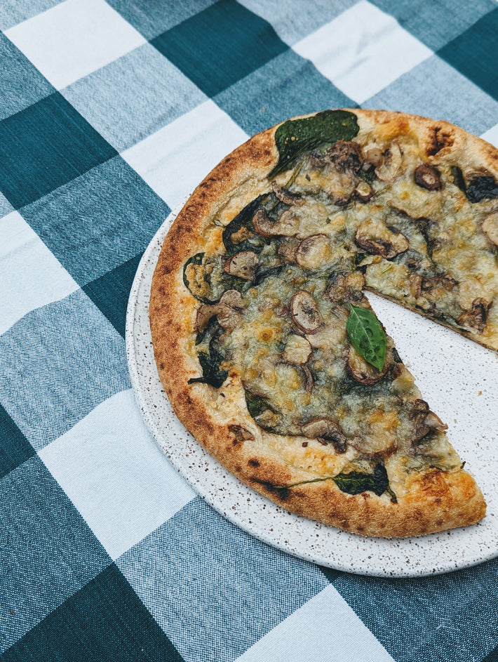 Slow-Fermented Veggie Pizza with mushrooms and spinach on a plate